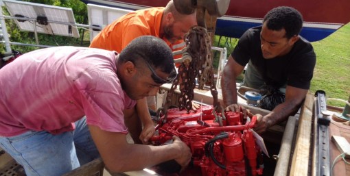 The boatyard guys get creative - lowering the engine down to Rick gearbox first